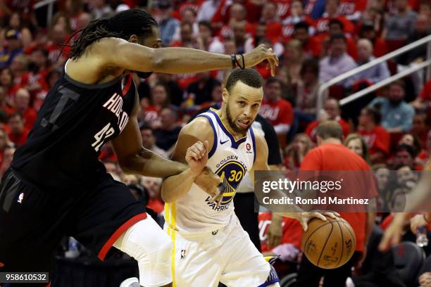 Stephen Curry of the Golden State Warriors handles the ball against Nene Hilario of the Houston Rockets in the second half in Game One of the Western...