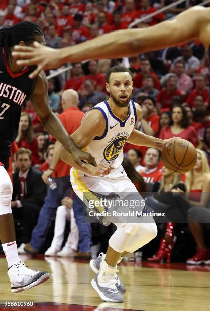 Stephen Curry of the Golden State Warriors handles the ball against Nene Hilario of the Houston Rockets in the second half in Game One of the Western...