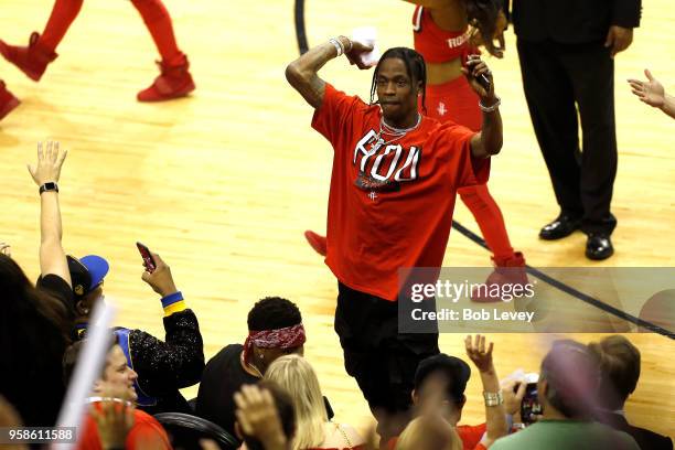 Rapper Travis Scott throws a t-shirt in to the crowd in Game One of the Western Conference Finals of the 2018 NBA Playoffs between the Houston...