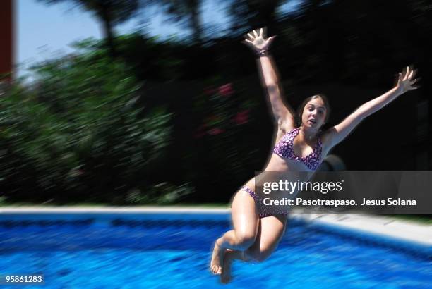 girl  jumping into swimming pool - jesus is alive stock pictures, royalty-free photos & images