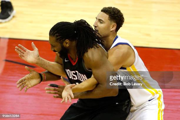 Klay Thompson of the Golden State Warriors defends Nene Hilario of the Houston Rockets in the second half in Game One of the Western Conference...