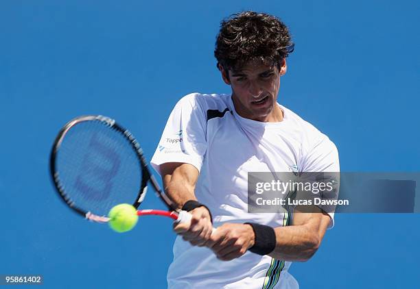 Thomaz Bellucci of Brazil plays a backhand in his first round match against Teimuraz Gabashvili of Russia during day two of the 2010 Australian Open...