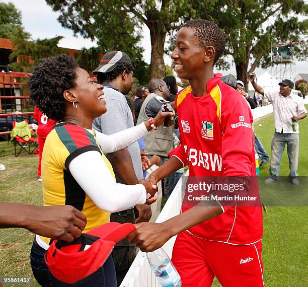 Zimbabwe cricketers are hugged by a supporters after the ICC U19 Cricket World Cup match between New Zealand and Zimbabwe at Bert Sutcliffe Oval on...