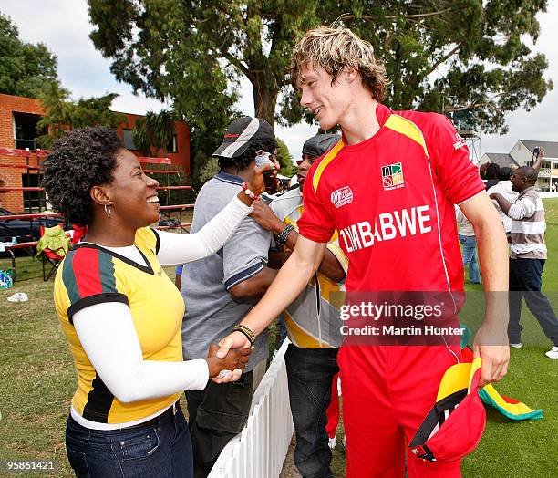 Nathan Waller of Zimbabwe is hugged by a supporter after the ICC U19 Cricket World Cup match between New Zealand and Zimbabwe at Bert Sutcliffe Oval...