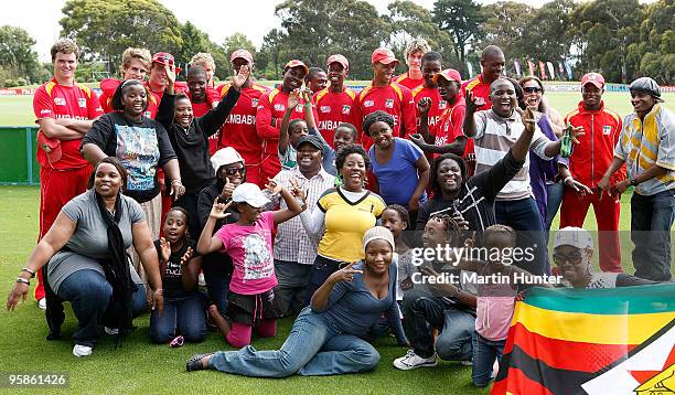 Zimbabwe cricketers pose with their supporters after the ICC U19 Cricket World Cup match between New Zealand and Zimbabwe at Bert Sutcliffe Oval on...