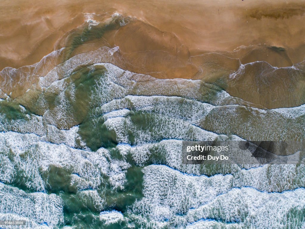 High view of beautiful sea wave with yellow sand beach.