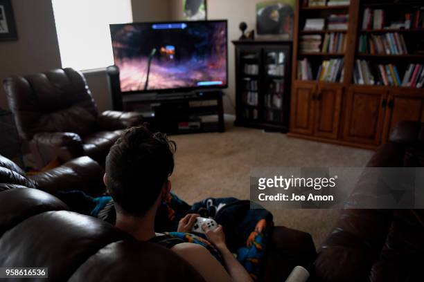 Stephen Morgan 22, working on his favorite pastime, video games at his home in Broomfield. Stephen came to live with Elizabeth Pate in December 2013,...