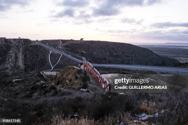 Painting reading in Spanish "140 periodistas asesinado en MX" is seen at a US/Mexico border fence section in Tijuana, Baja California State, Mexico,...