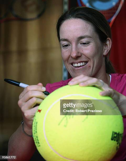 Justine Henin of Belgium signs autographs for fans during day two of the 2010 Australian Open at Melbourne Park on January 19, 2010 in Melbourne,...