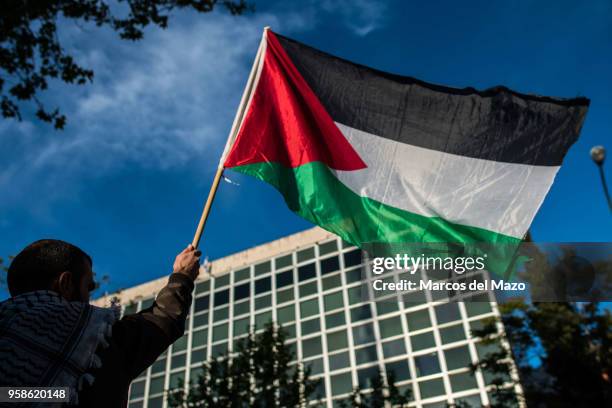 Man waiving a Palestinian flag protesting in front of the Embassy of Israel against last deaths in Gaza Strip ahead of the 70th anniversary of Nakba.