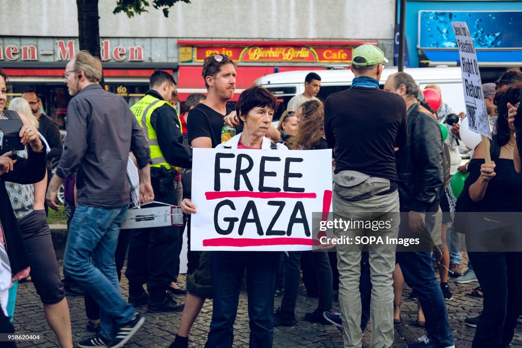 Woman with a banner reading "free Gaza" at the protest the...