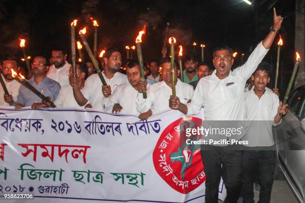 All Assam Students Union during a torchlight protest in Guwahati against the Citizenship Bill 2016. The Bill amends the Citizenship Act of 1955 to...