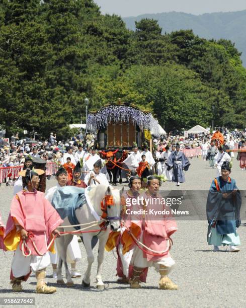 People in ancient Japanese court-style attire parade in the annual Aoi Matsuri, one of the three main festivals of Kyoto, on May 15, 2018. ==Kyodo