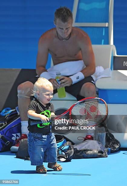 Lleyton Hewitt of Australia takes a break with his son Cruz during a practice session in the lead-up to the Australian Open tennis tournament in...