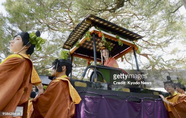 Shiho Sakashita , a 23-year-old office worker, clad in a 12-layer traditional Japanese kimono, aboard a float for a parade in the annual Aoi Matsuri,...