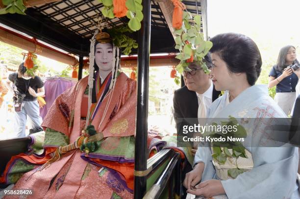 Shiho Sakashita , a 23-year-old office worker, clad in a 12-layer traditional Japanese kimono, in a float for a parade in the annual Aoi Matsuri, one...