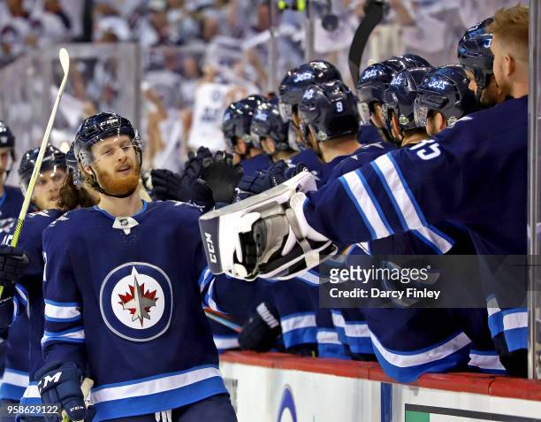 Kyle Connor of the Winnipeg Jets celebrates his third period goal against the Vegas Golden Knights with teammates at the bench in Game Two of the...