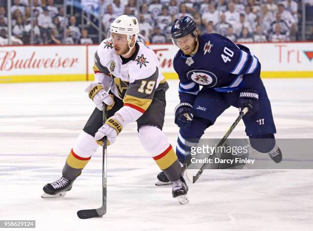 Reilly Smith of the Vegas Golden Knights plays the puck down the ice as Joel Armia of the Winnipeg Jets gives chase during third period action in...