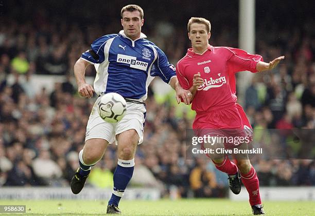 Michael Owen of Liverpool and David Unsworth of Everton chase a loose ball during the FA Barclaycard Premiership match played at Goodison Park, in...