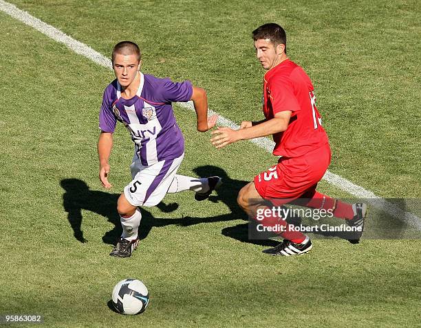 Joshua Risdon of the Glory is pressured by Francesco Monterosso of United during the round 15 National Youth League match between Adelaide United and...