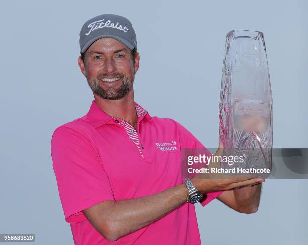 Webb Simpson of the United States celebrates with the winner's trophy after the final round of THE PLAYERS Championship on the Stadium Course at TPC...