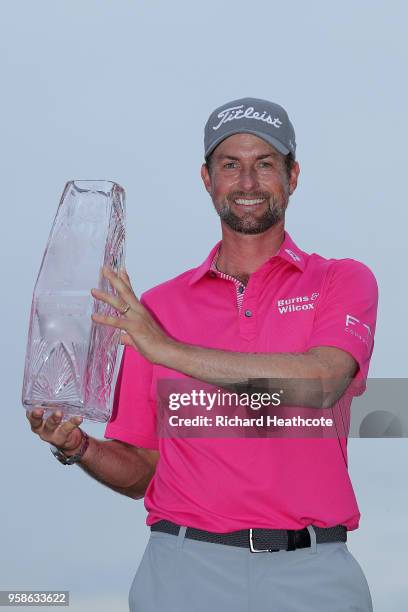 Webb Simpson of the United States celebrates with the winner's trophy after the final round of THE PLAYERS Championship on the Stadium Course at TPC...