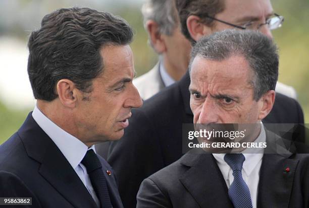 French President Nicolas Sarkozy chats with the President of French energy giant EDF Henri Proglio, during the openning of a solar plant in Saint...