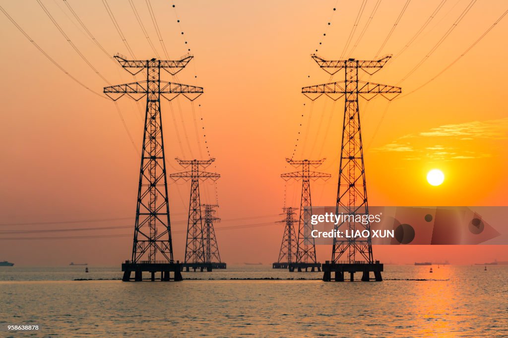 One row of high voltage tower in the sea at dust