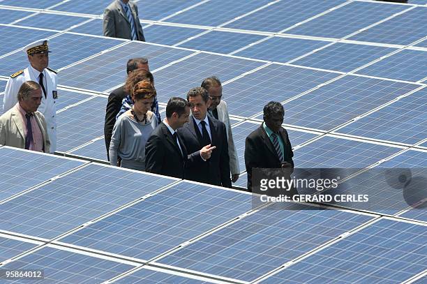 French President Nicolas Sarkozy , and Junior Minister for Ecology Chantal Jouanno visit a solar plant during its opening in Saint-Pierre de La...