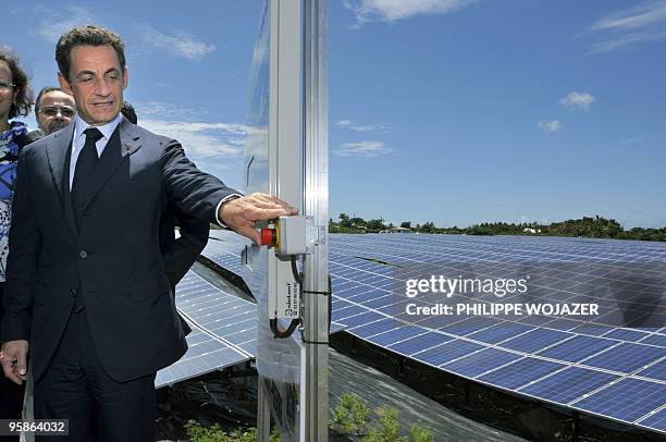 French President Nicolas Sarkozy turns on solar panels as he visits a solar plant for its opening in Saint-Pierre de La Reunion island on January 19,...