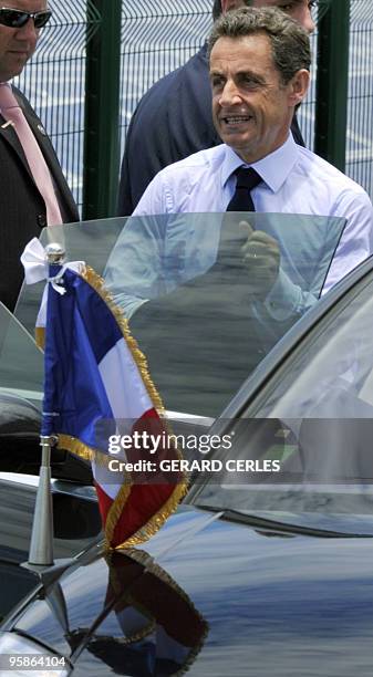 French President Nicolas Sarkozy enters his car after he visited a solar a solar plant in Saint-Pierre de La Reunion island on January 19, 2010...