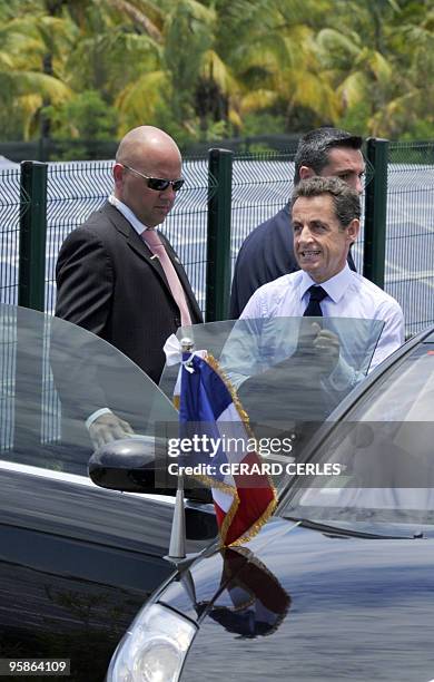 French President Nicolas Sarkozy enters his car after he visited a solar a solar plant in Saint-Pierre de La Reunion island on January 19, 2010...