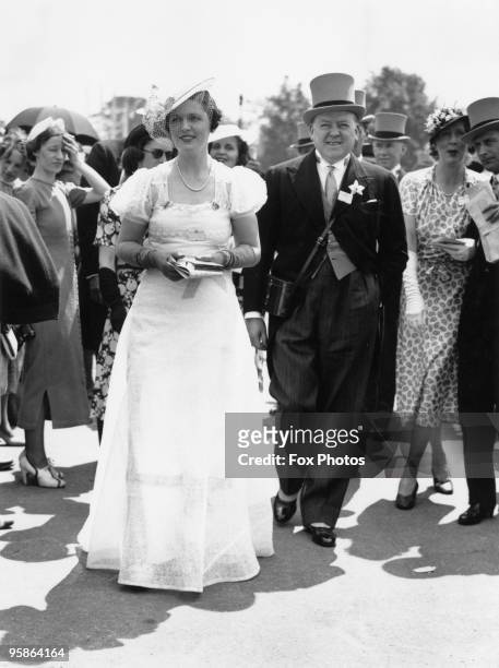 British Conservative MP and businessman Captain Leonard Plugge with his wife Ann at the Royal Ascot race meeting, June 1938. Plugge's main commercial...