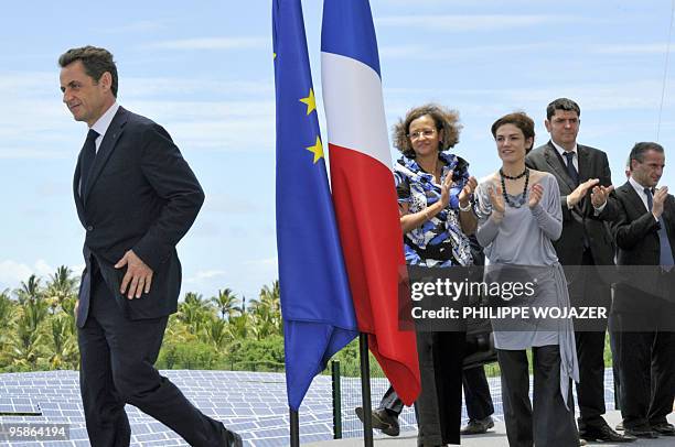 French President Nicolas Sarkozy leaves after delivering a speech for the openning of a solar plant as Junior Minister for Ecology Chantal Jouanno...