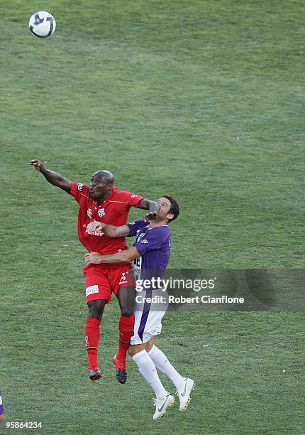 Lloyd Owusu of Adelaide United challenges Chris Coyne of Perth Glory during the round 19 A-League match between Adelaide United and Perth Glory at...