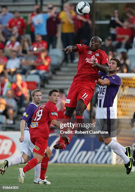 Lloyd Owusu of Adelaide United challenges Chris Coyne of Perth Glory during the round 19 A-League match between Adelaide United and Perth Glory at...