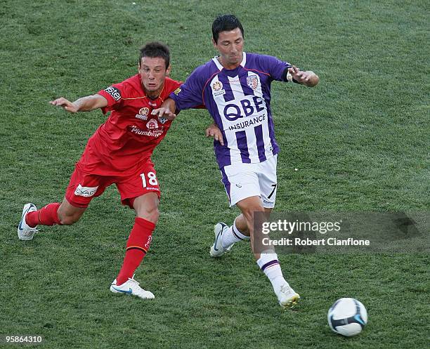 Jacob Burns of Perth Glory is pressured by Fabian Barbiero of Adelaide United during the round 19 A-League match between Adelaide United and Perth...