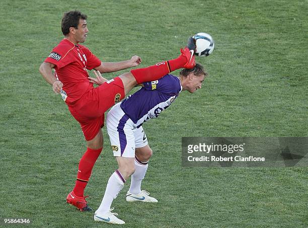 Mark Rudan of Adelaide United challenges Daniel McBreen of Perth Glory during the round 19 A-League match between Adelaide United and Perth Glory at...