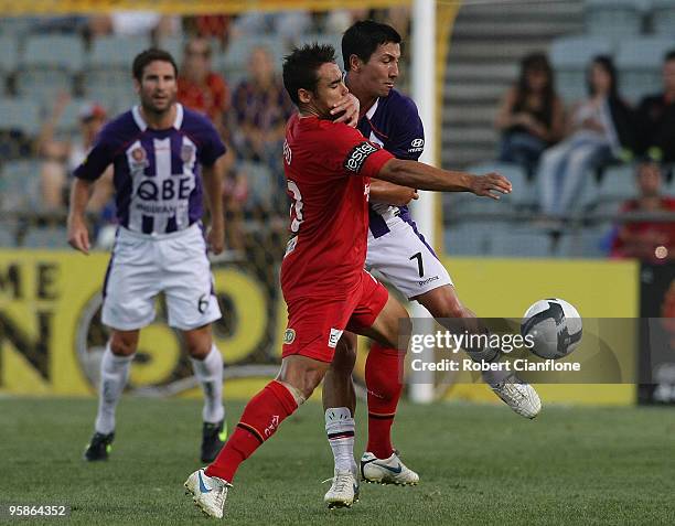 Travis Dodd of Adelaide United is challenged by Jacob Burns of Perth Glory during the round 19 A-League match between Adelaide United and Perth Glory...