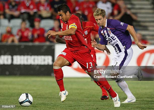 Travis Dodd of Adelaide United gets away from Jamie Coyne of Perth Glory to score during the round 19 A-League match between Adelaide United and...