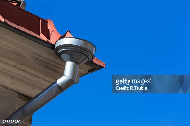 rain gutters on old home. there is a blue sky in the background. - rock overhang stock pictures, royalty-free photos & images