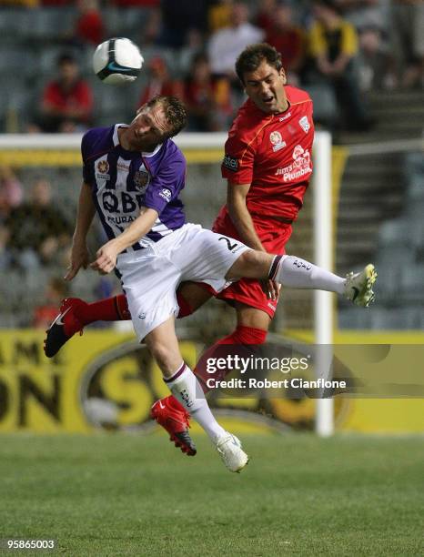 Daniel McBreen of Perth Glory is challenged by Mark Rudan of Adelaide United during the round 19 A-League match between Adelaide United and Perth...