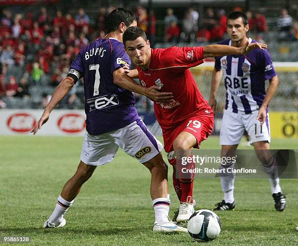 Lucas Pantelis of Adelaide United is challenged by Jacob Burns of Perth Glory during the round 19 A-League match between Adelaide United and Perth...