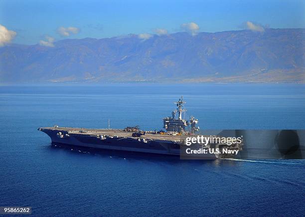 In this handout image provided by the US Navy, The Nimitz-class aircraft carrier USS Carl Vinson maneuvers on January 18, 2010 in Port-Au-Prince, off...