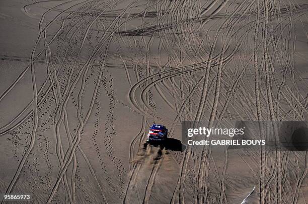 France's Stephane Peterhansel steers his BMW during the 13th stage of the Dakar 2010, between San Rafael and Santa Rosa, Argentina on January 15,...