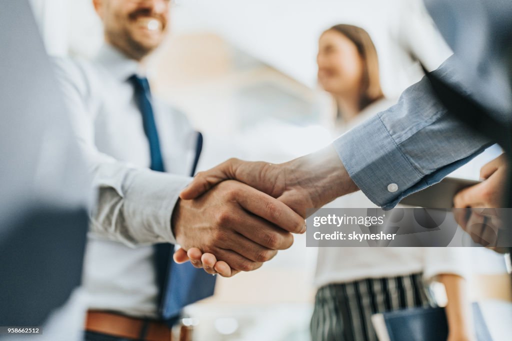 Close up of unrecognizable business colleagues reaching an agreement in the office.