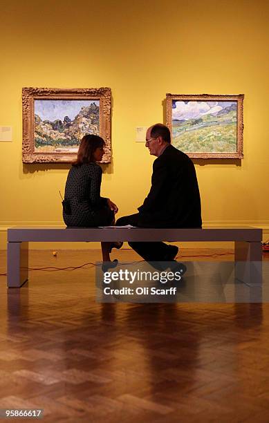 Man and a woman discuss the oil paintings by acclaimed Dutch artist Vincent Van Gogh at the press viewing of an exhibition of his work held at the...