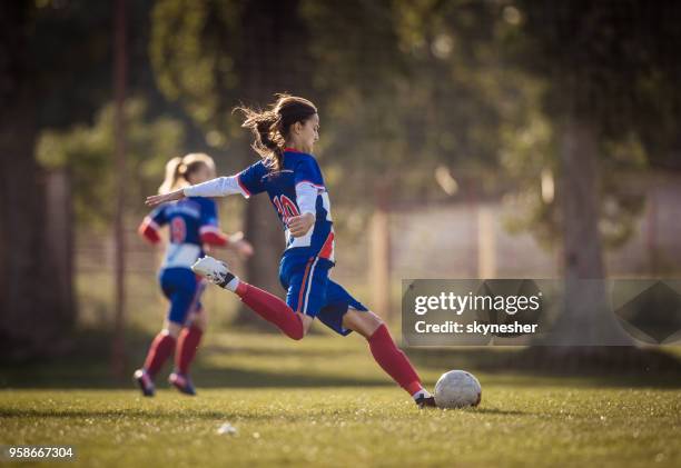 teenage soccer player in action on a playing field. - soccer championship stock pictures, royalty-free photos & images