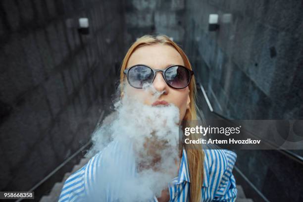 girl smoking electronic cigarette - electronic cigarette smoke stockfoto's en -beelden