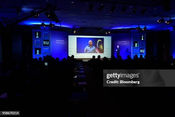 Mahathir Mohamad, Malaysia's prime minister, is displayed on a screen while speaking via a video link to the participants at the Wall Street Journal...